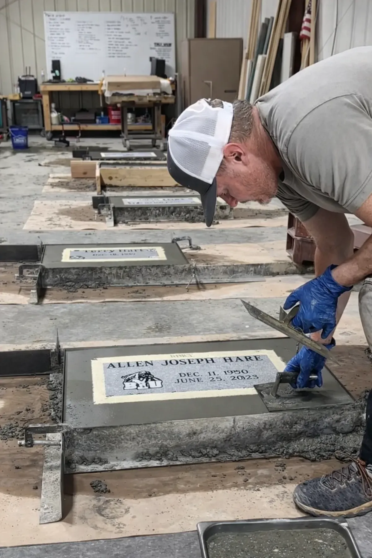 A craftsman cleaning and finishing an engraved marker before installation